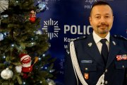 Zdjęcie przedstawia Komendanta Wojewódzkiego Policji w Olsztynie - nadinsp. Tomasza Klimka. W tle świąteczna choinka i logo KWP w Olsztynie.