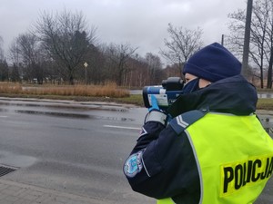 Zdjęcie przedstawia policjantkę kontrolującą prędkość.